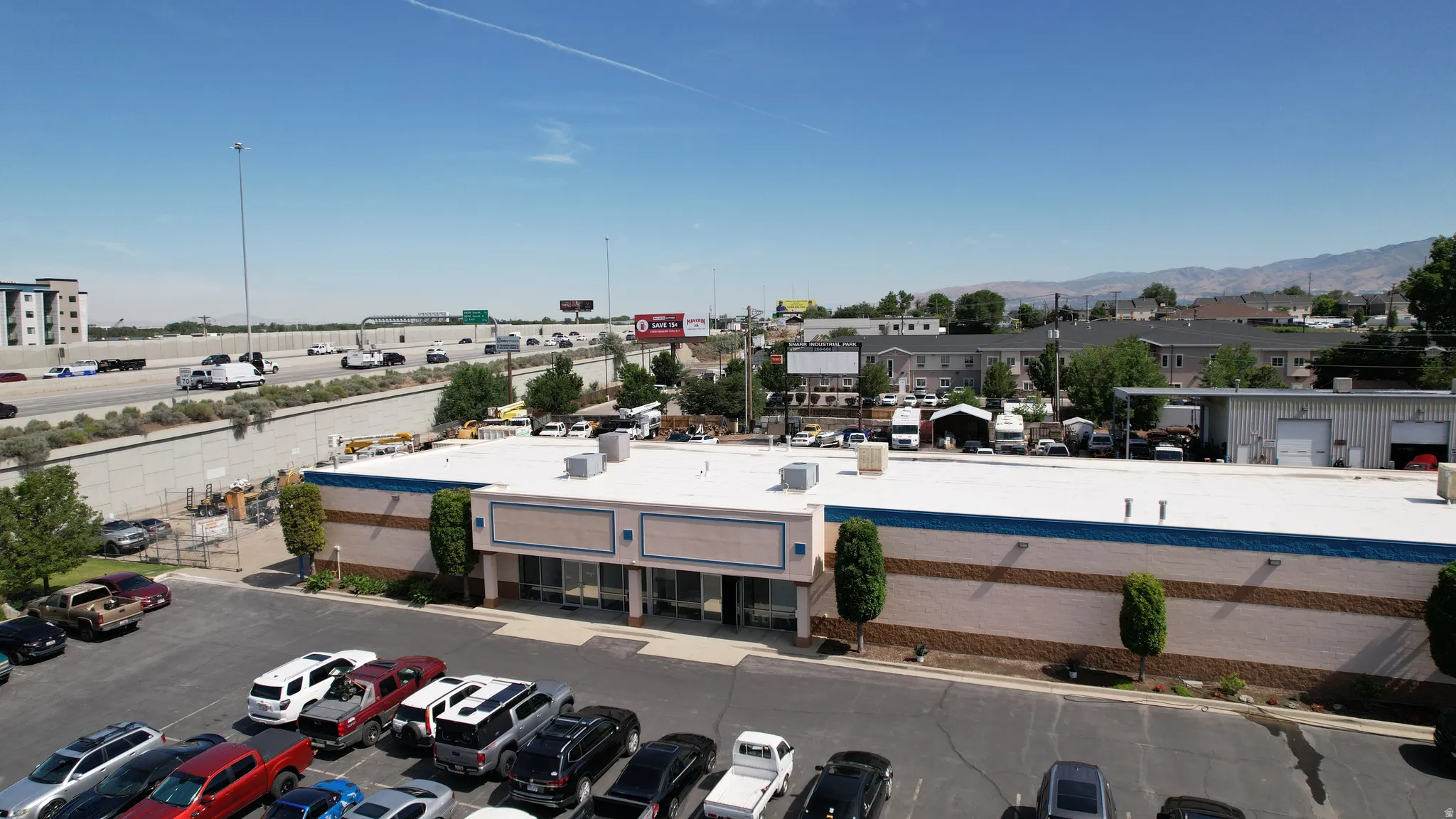 Commercial building with a spacious parking lot, multiple storefront windows, and a flat roof