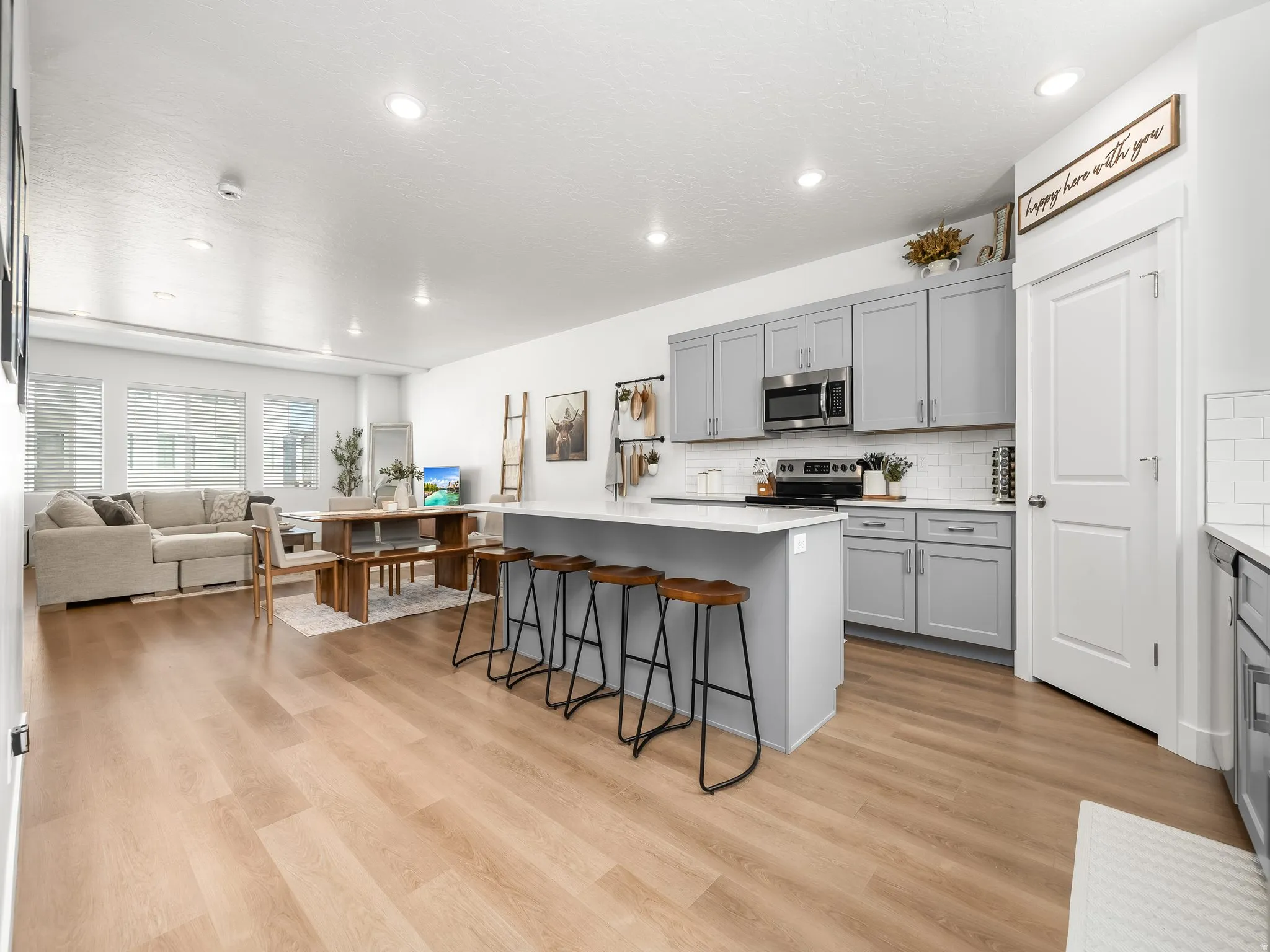 Open-concept living area featuring light wood-finish flooring throughout