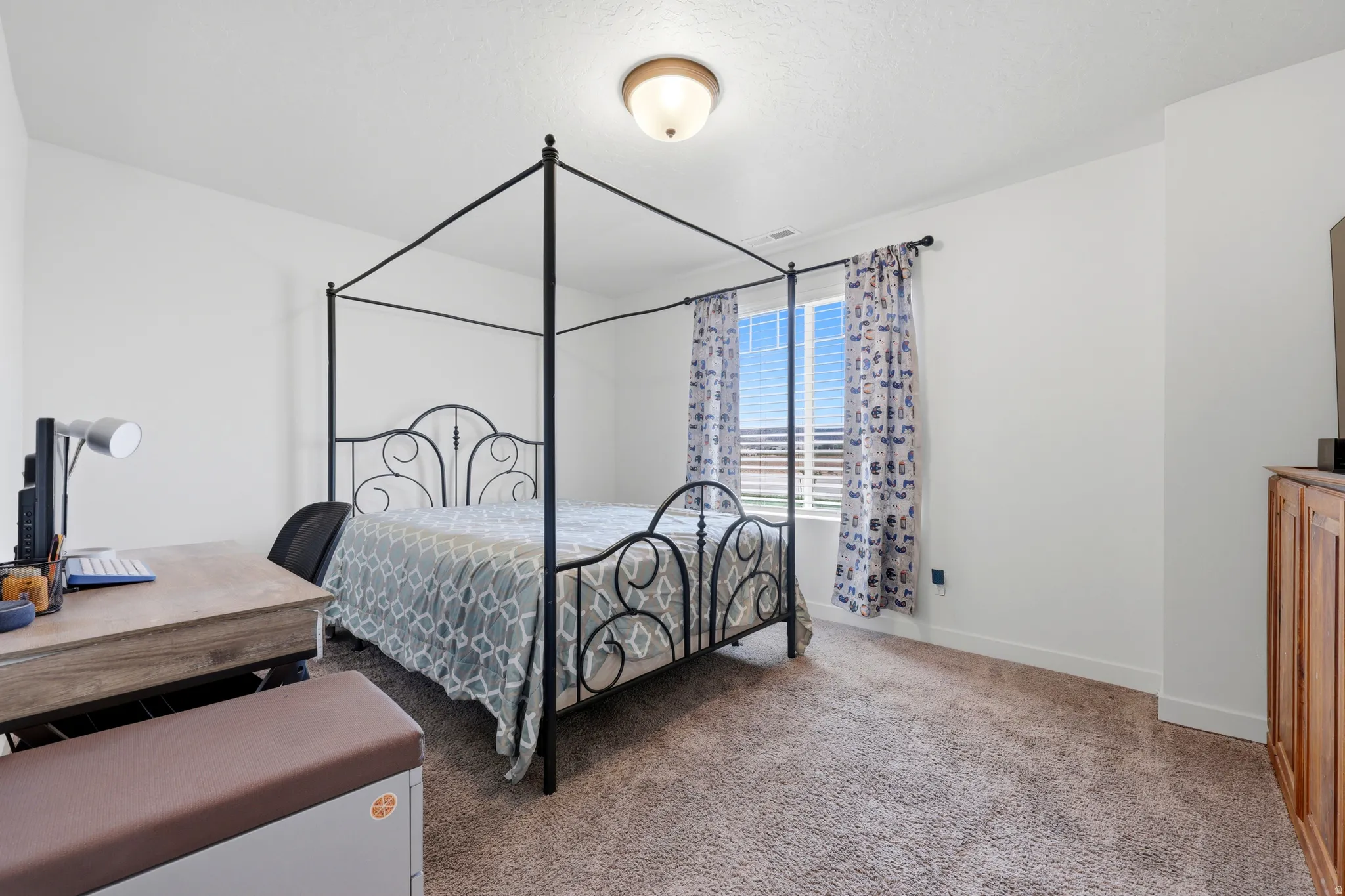 Carpeted room with white walls, a single window, and a flush-mount ceiling light fixture