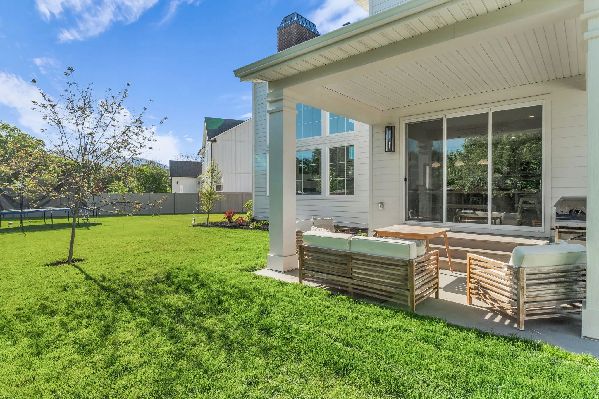 Spacious backyard with manicured lawn and mature trees