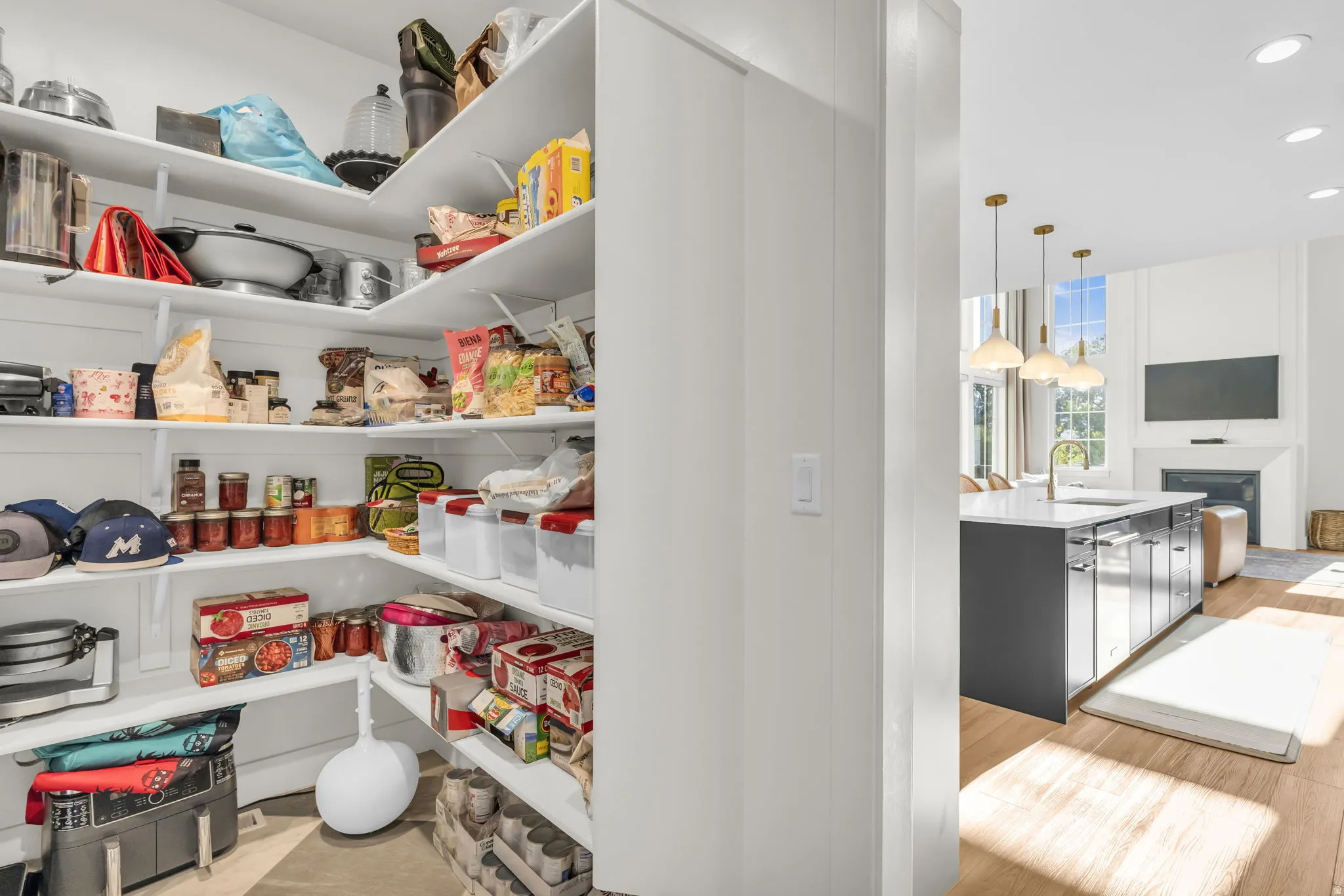 Corner pantry with multiple levels of shelving, offering extensive storage