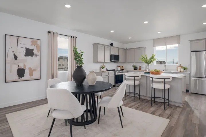 Open-concept kitchen and dining area featuring wood-finish flooring