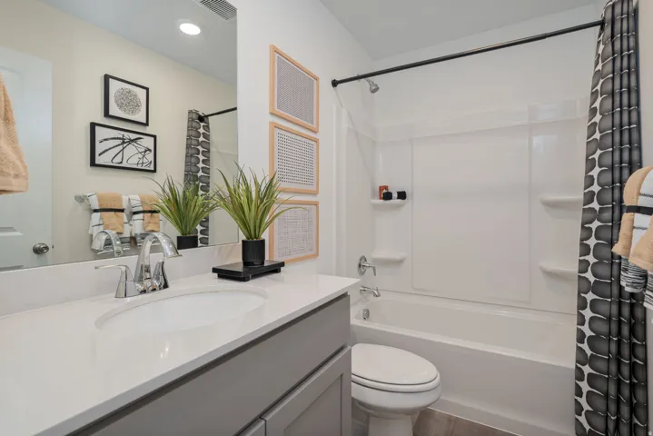 Bathroom vanity featuring a polished chrome faucet and a built-in sink basin