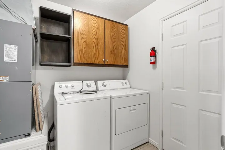 Dedicated laundry area featuring white washer and dryer units