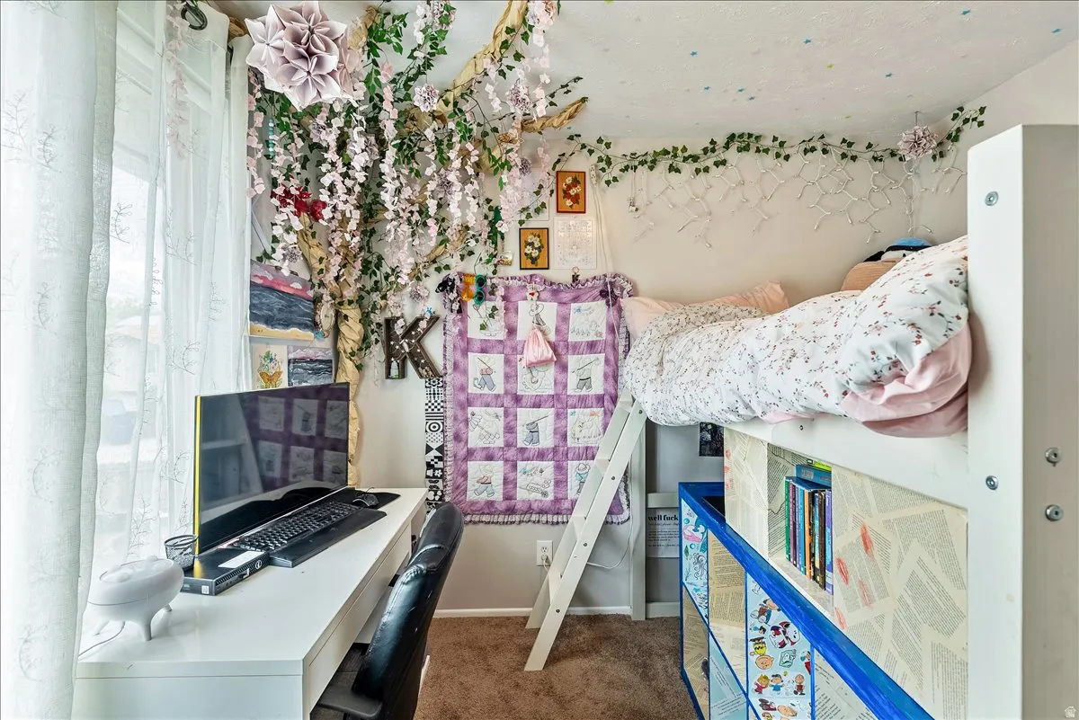 Built-in loft bed with integrated shelving, accompanied by a dedicated desk area