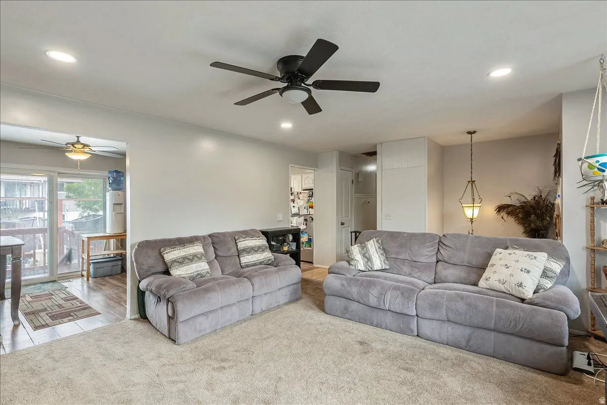 Living area featuring recessed lighting, a ceiling fan, and carpeted flooring
