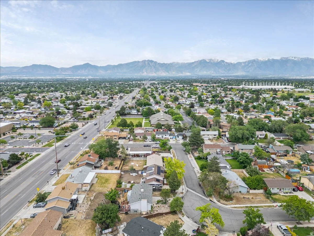 Expansive residential area with a prominent roadway and distant snow-capped mountains