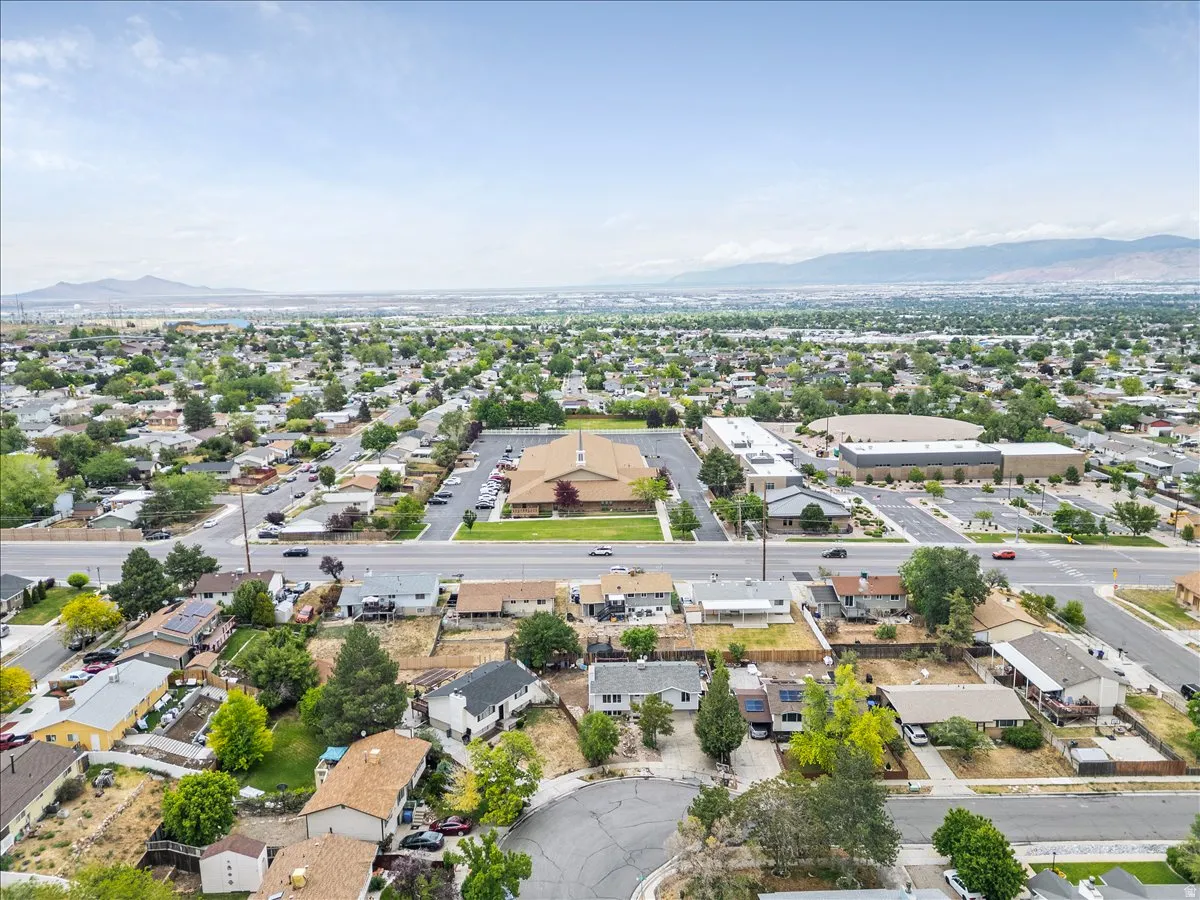 Expansive aerial perspective showcasing a residential area with varied housing styles and mature landscaping