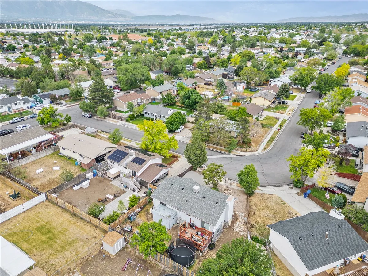 Aerial perspective showcasing a residential neighborhood with a mountain backdrop