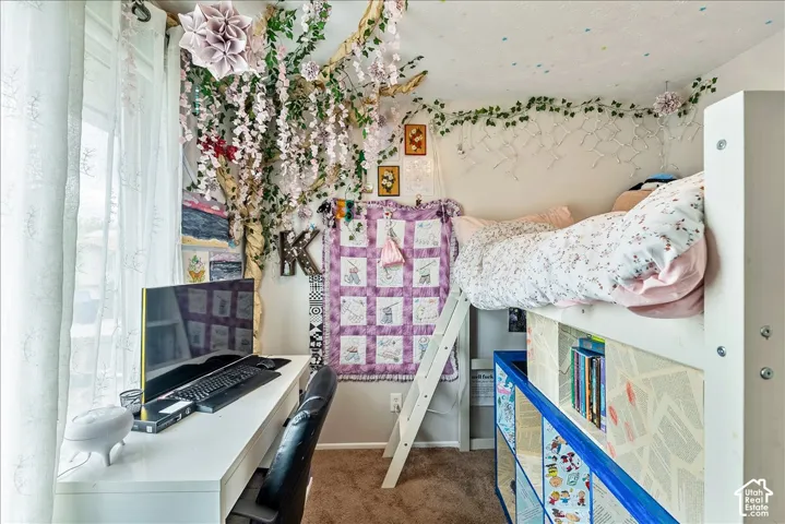 Built-in loft bed with integrated shelving, accompanied by a dedicated desk area