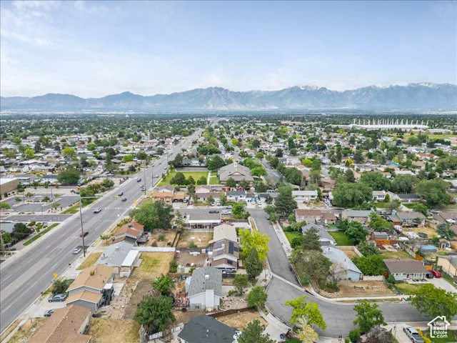 Expansive residential area with a prominent roadway and distant snow-capped mountains