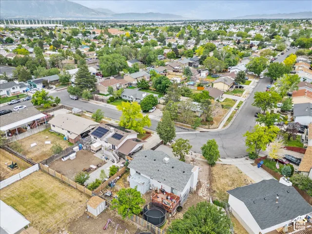 Aerial perspective showcasing a residential neighborhood with a mountain backdrop