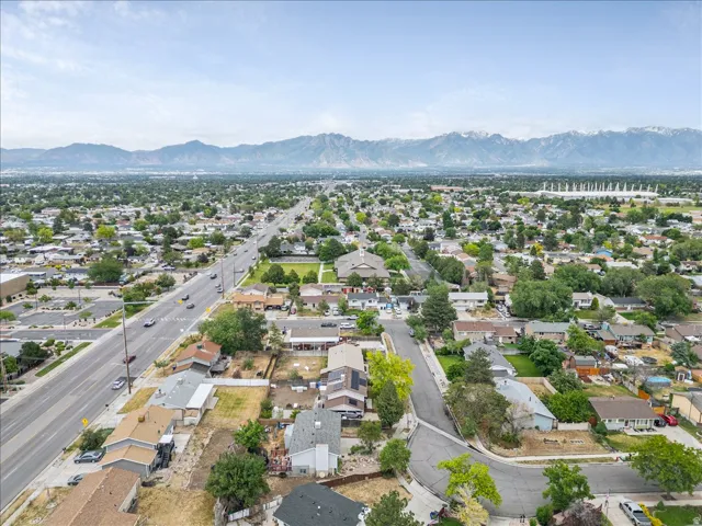 Expansive residential area with a prominent roadway and distant snow-capped mountains