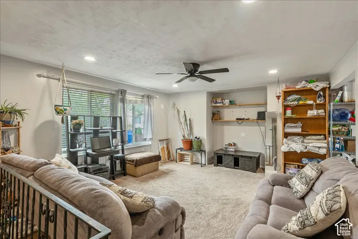 Carpeted living space featuring recessed lighting and a ceiling fan