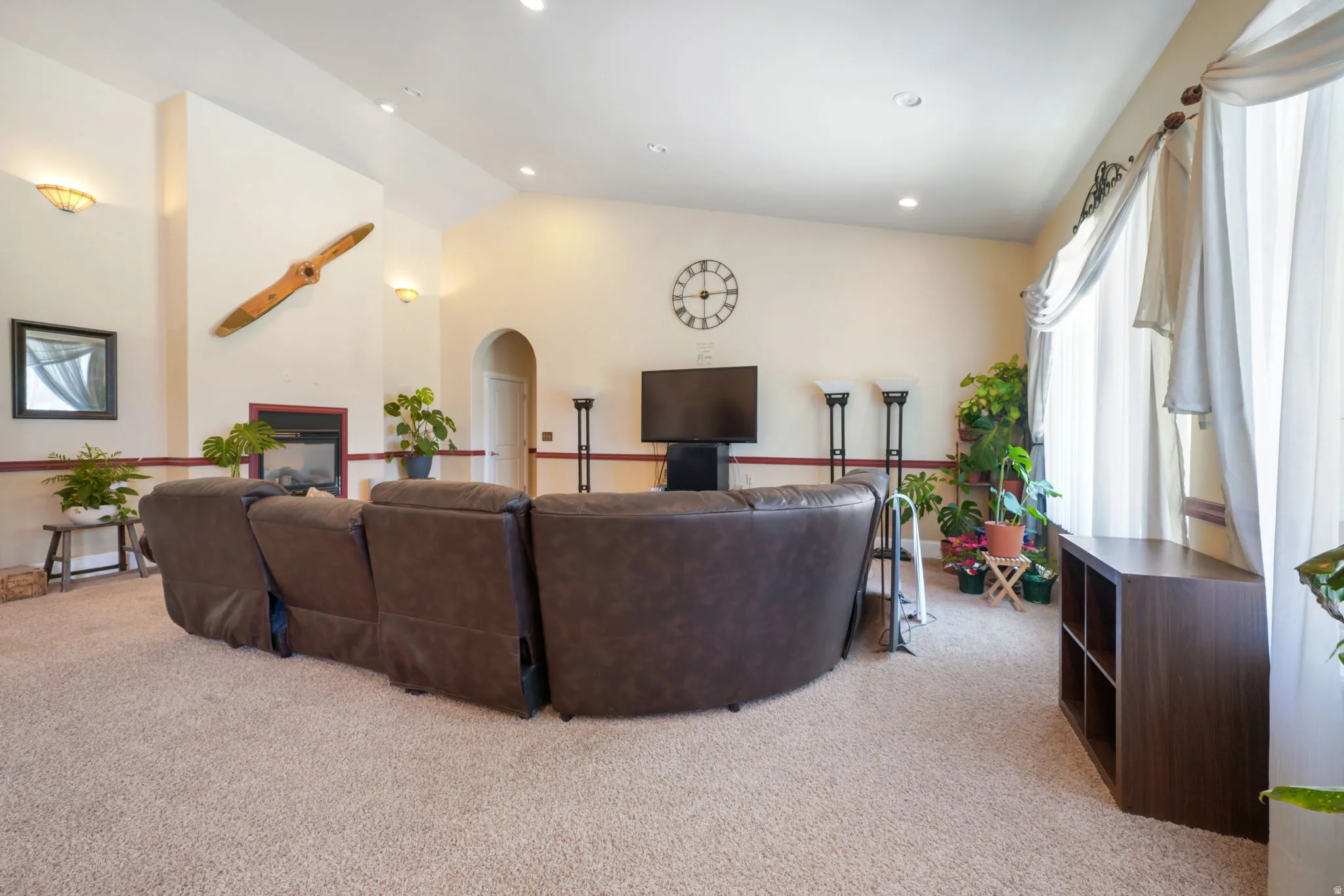 Vaulted ceilings, recessed lighting, see through built-in fireplace, and  large windows