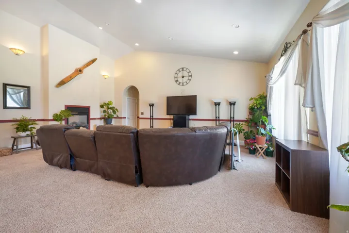 Vaulted ceilings, recessed lighting, see through built-in fireplace, and  large windows