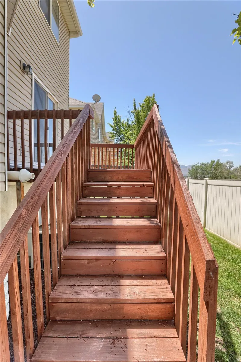 Wood-finish deck stairs with railings providing access to the property's exterior