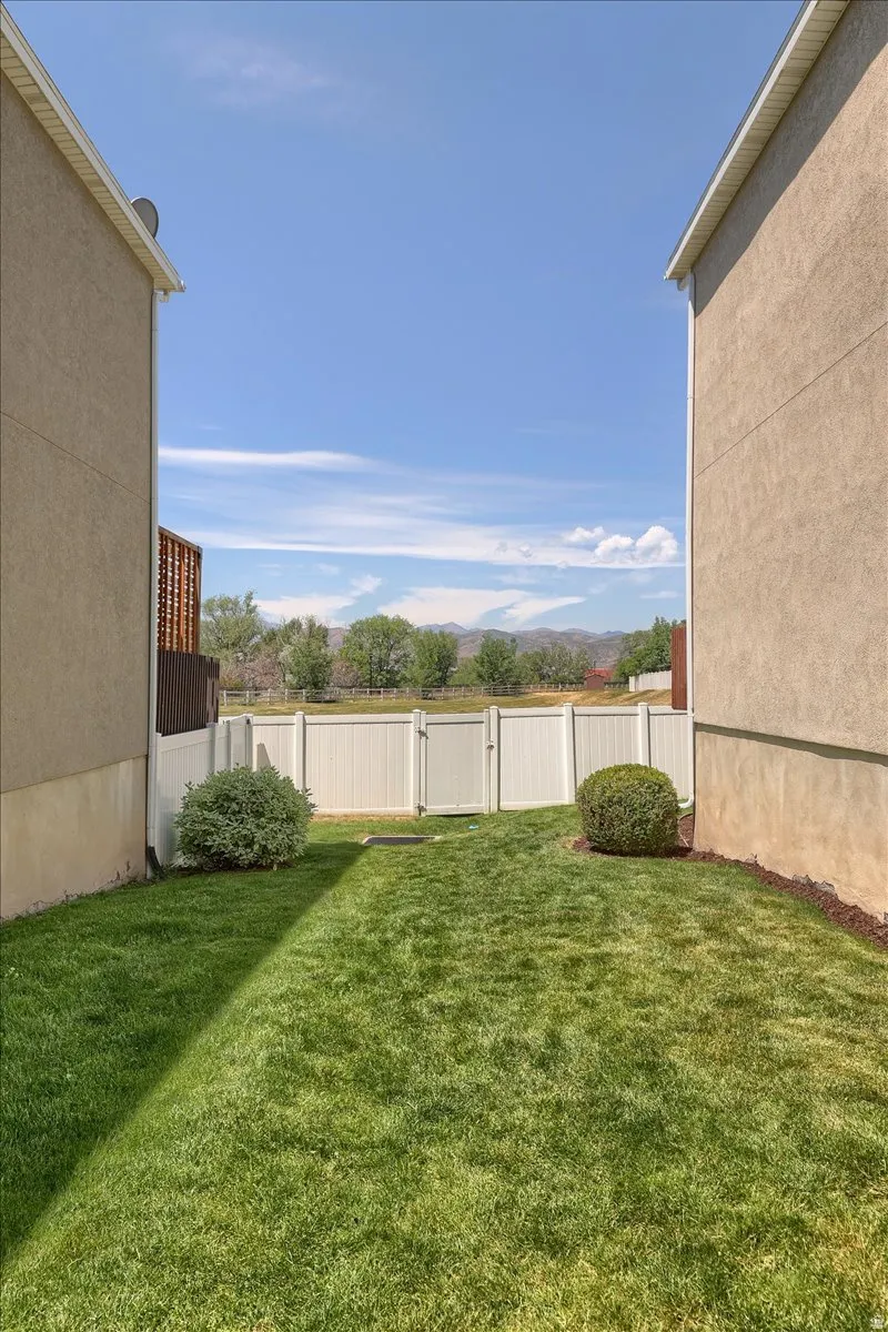 Private backyard featuring a well-maintained lawn and perimeter fencing
