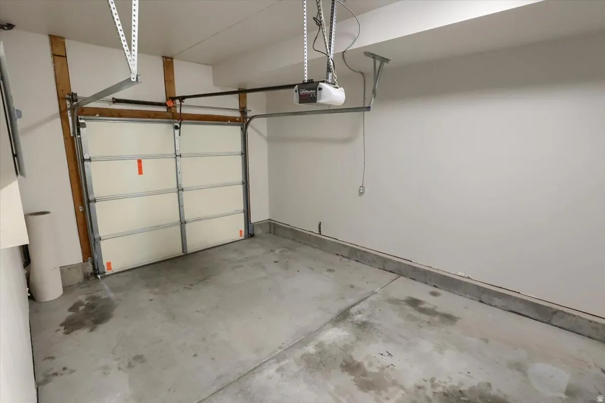 Single-bay garage with a concrete floor and white walls
