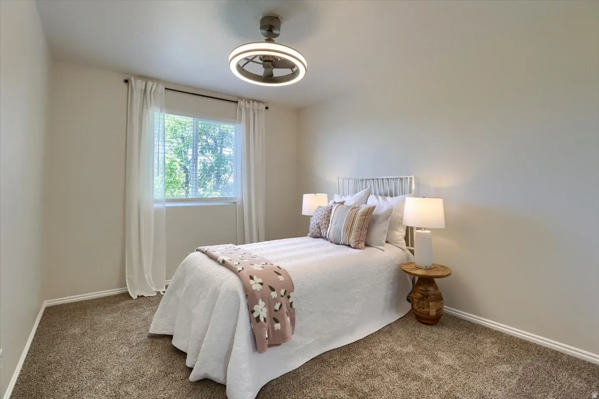 Bedroom featuring light tan walls and plush brown carpeting