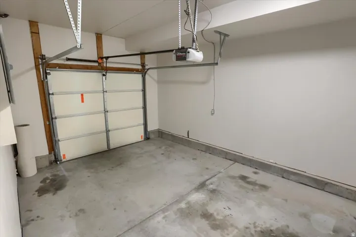 Single-bay garage with a concrete floor and white walls