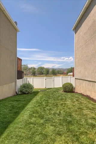 Private backyard featuring a well-maintained lawn and perimeter fencing
