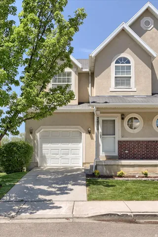 Stucco exterior with an arched window and two circular windows