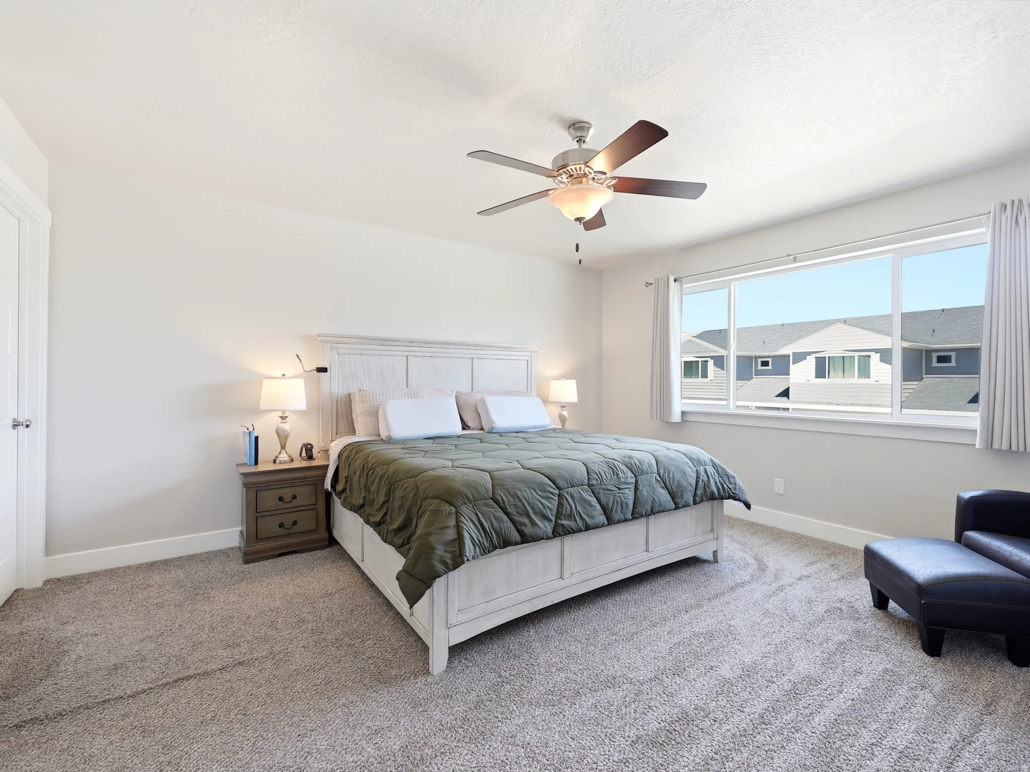 Bedroom featuring a large window, neutral paint, recessed lighting, and a ceiling fan