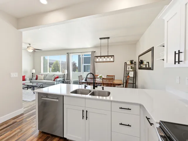 Kitchen island with a double basin sink, stainless steel faucet, and dishwasher