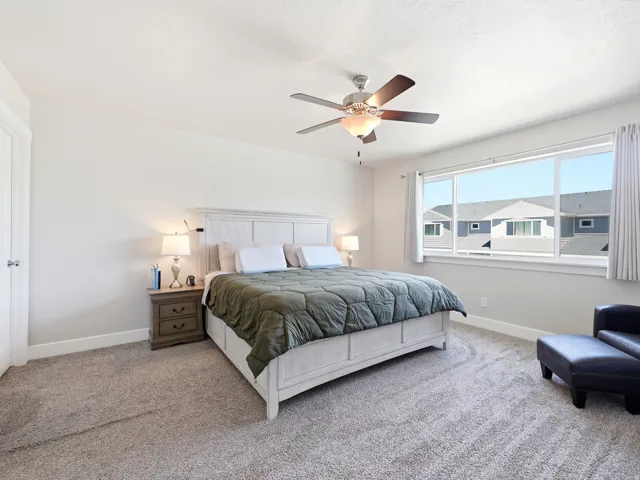 Bedroom featuring a large window, neutral paint, recessed lighting, and a ceiling fan