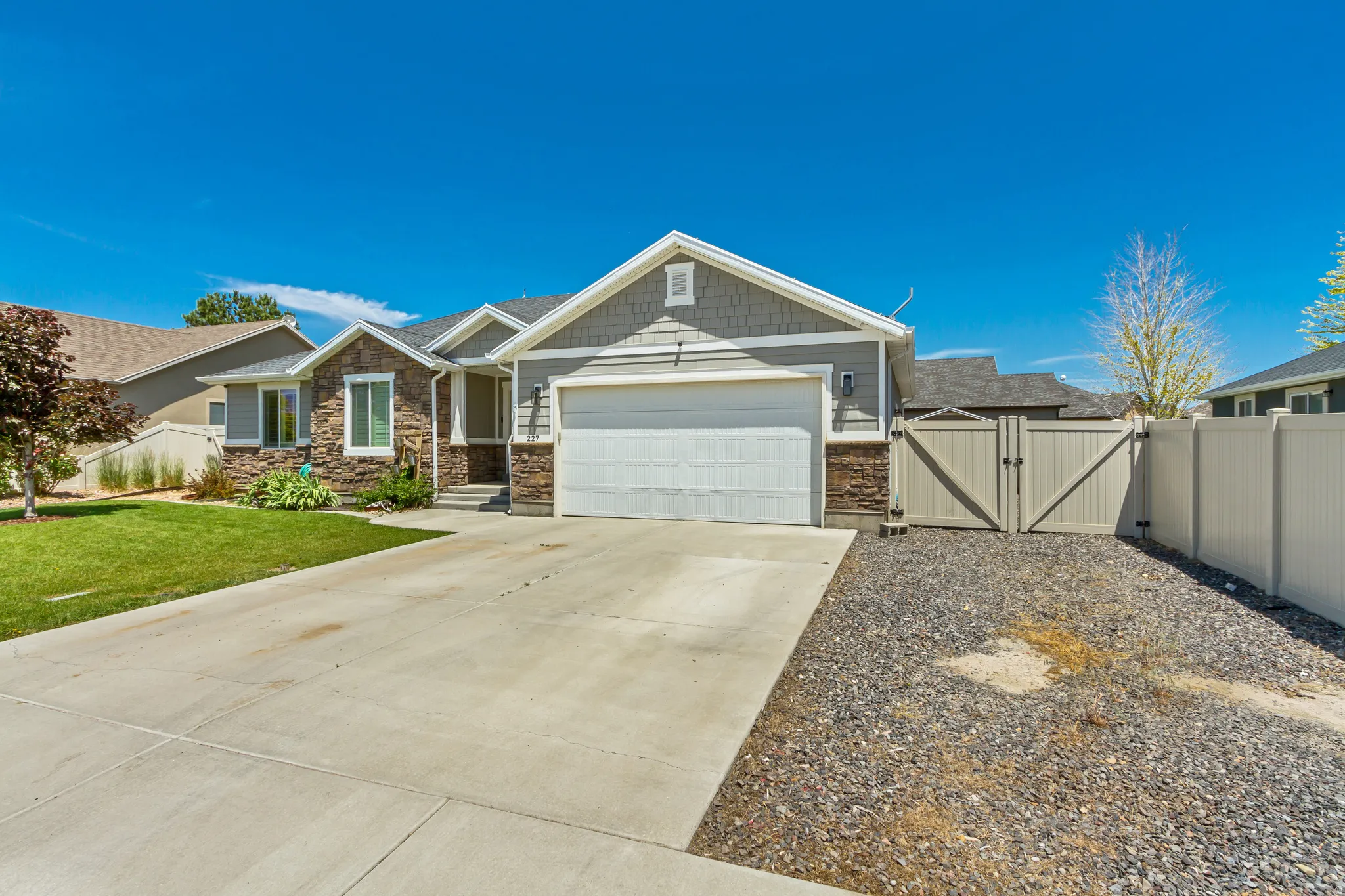 Contemporary gray siding exterior with stone accents