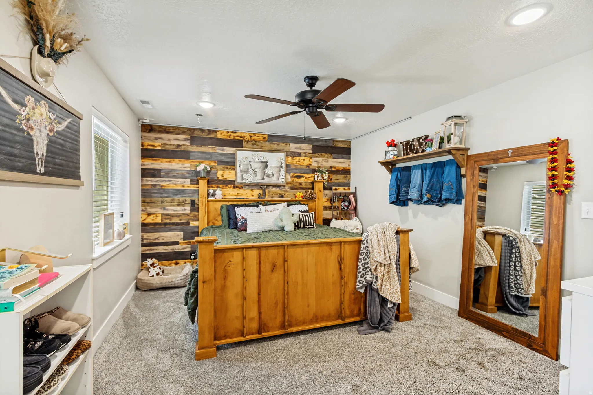 Spacious room featuring a prominent wood accent wall, recessed lighting, and a ceiling fan with integrated lighting