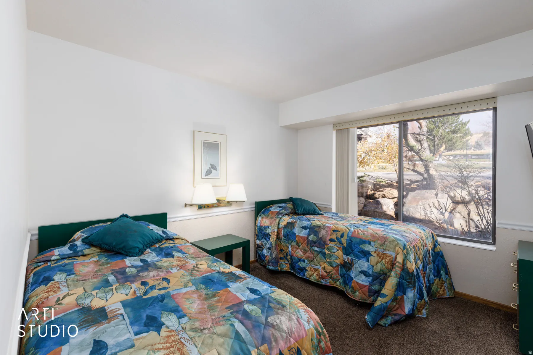 Bedroom featuring a large picture window, wall-mounted lighting, and neutral wall tones