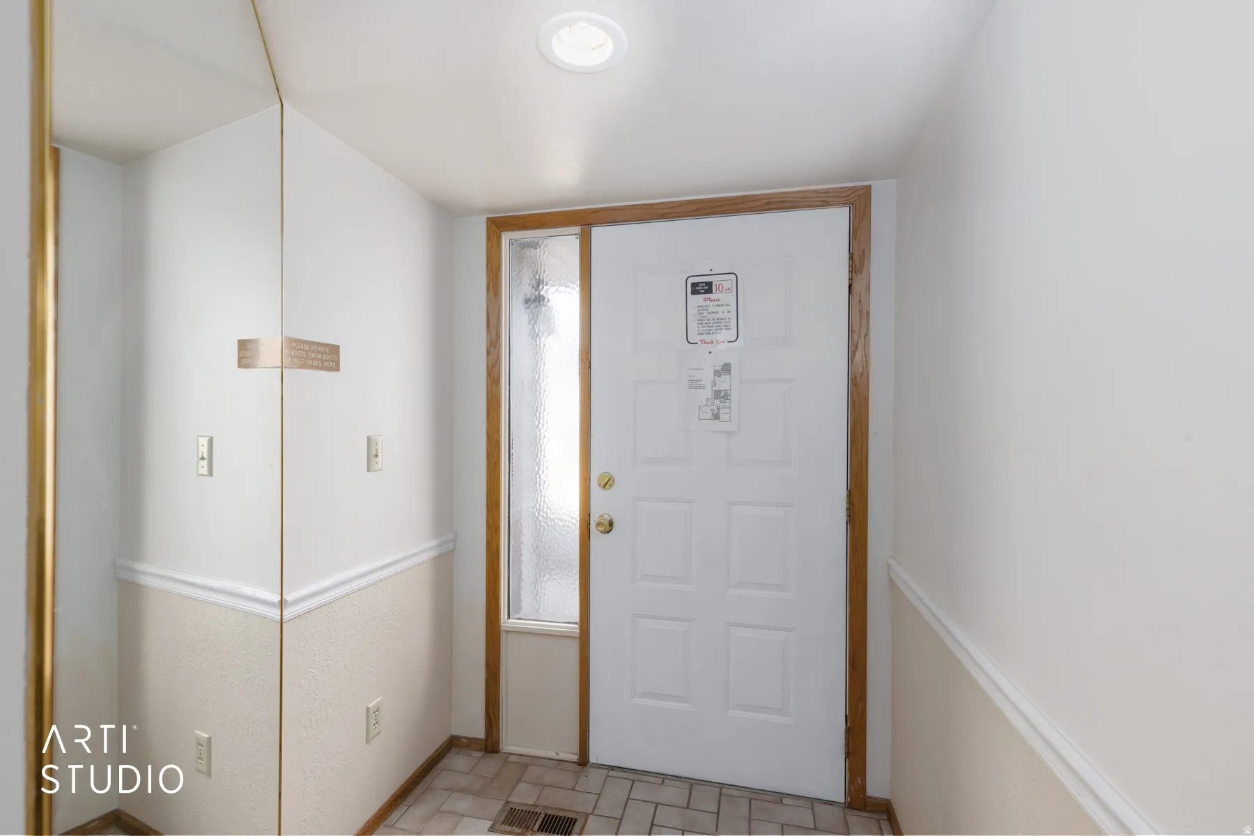 Entryway featuring a paneled door with wood trim, a textured glass sidelight, and recessed lighting