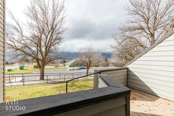 Outdoor deck featuring composite decking and railing, with a backdrop of distant mountains