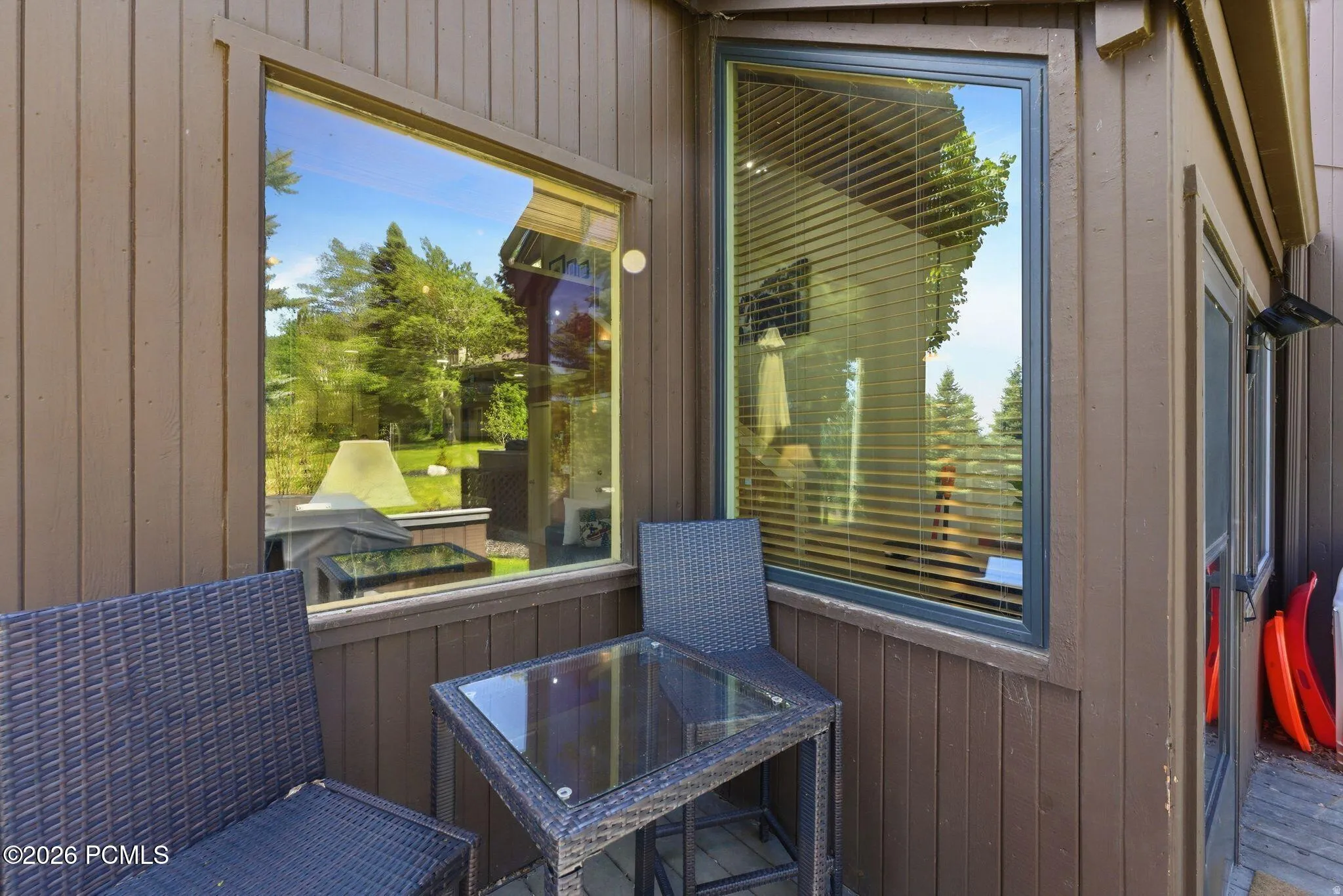 Exterior patio space featuring brown vertical siding