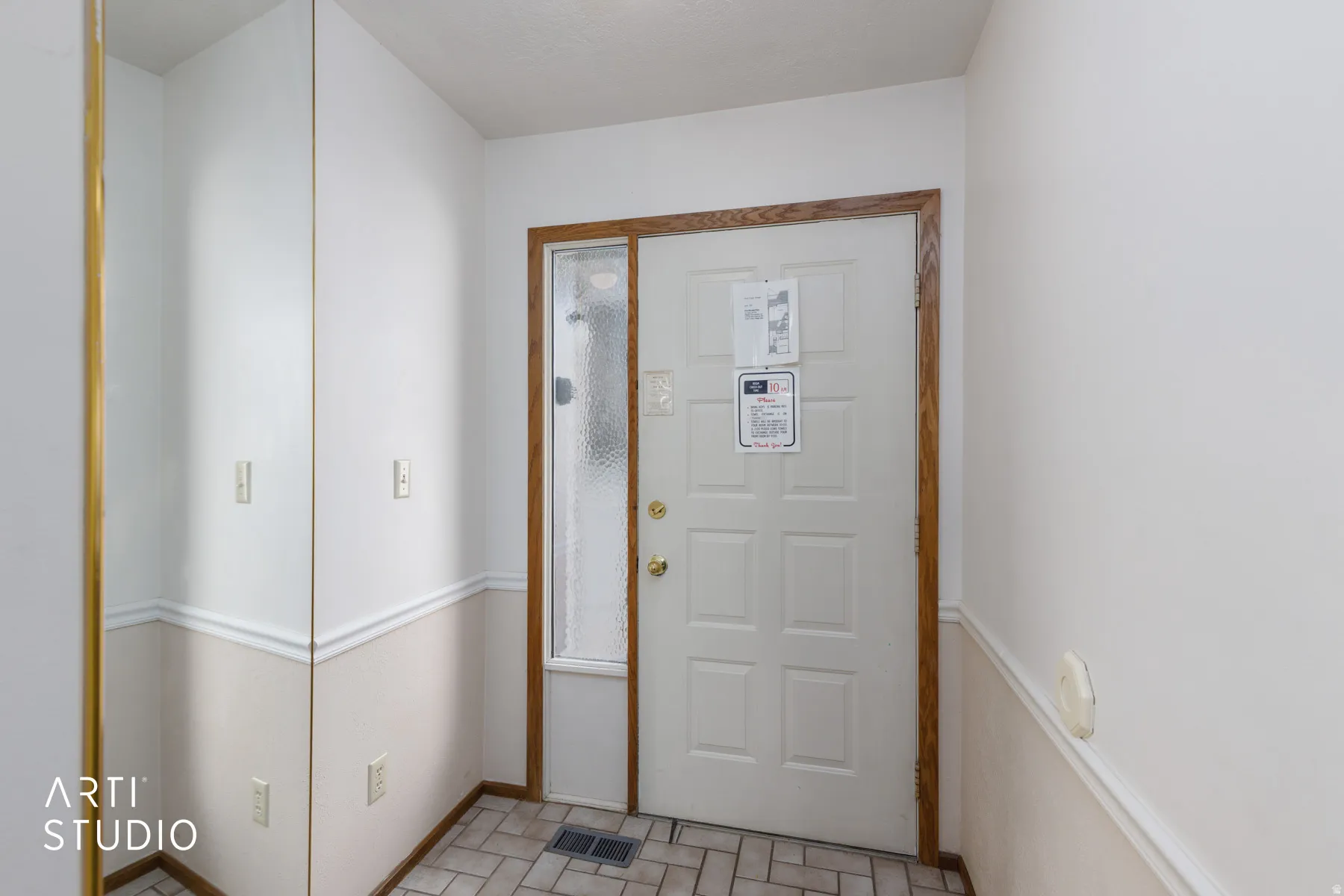 Entryway featuring a paneled door with wood-finish trim and an adjacent full-length sidelight