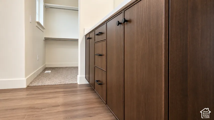 Custom dark wood cabinetry featuring flat-panel doors, integrated drawers, and matte black hardware