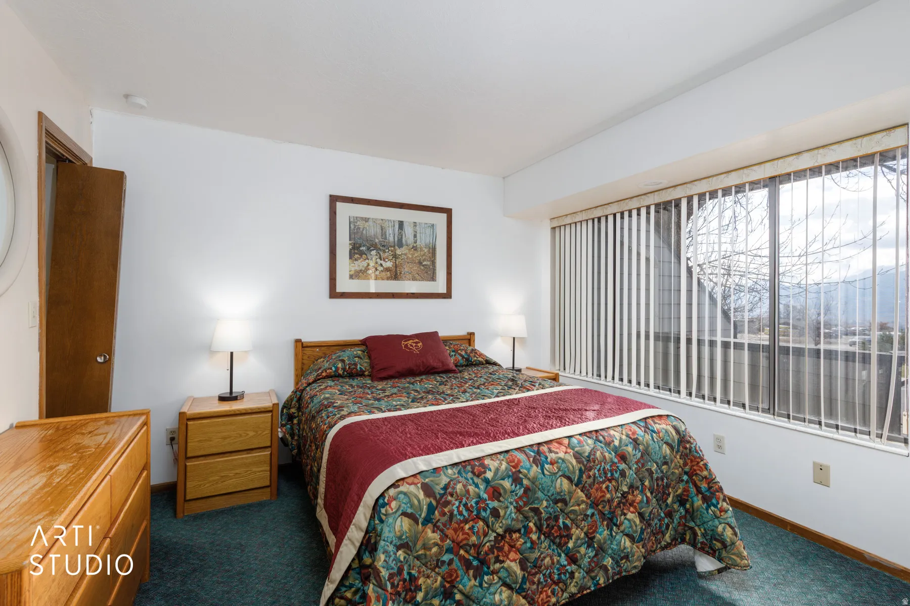 Bedroom featuring a full-width window with vertical blinds, light blue carpeting, and a white ceiling