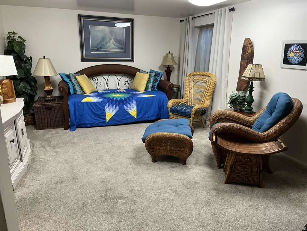 Carpeted room featuring a window with white drapes, a white built-in cabinet, and recessed lighting