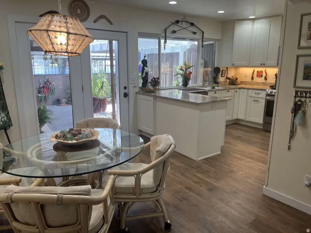 Kitchen featuring white shaker-style cabinetry, granite countertops, and stainless steel appliances