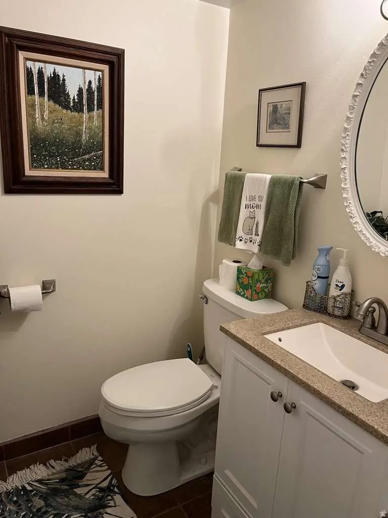 Bathroom featuring a white vanity with paneled doors, a light-colored countertop, and a built-in sink with a chrome faucet