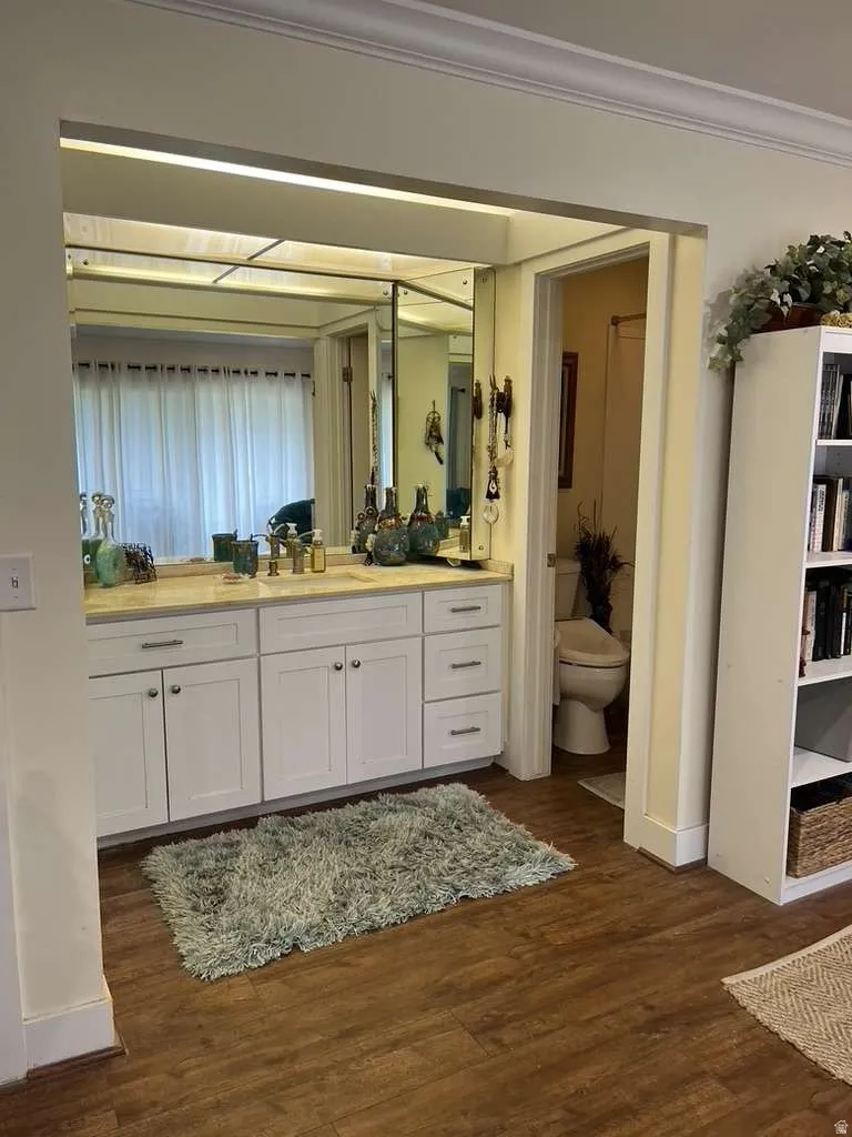 Double vanity with white cabinetry and light-toned countertop