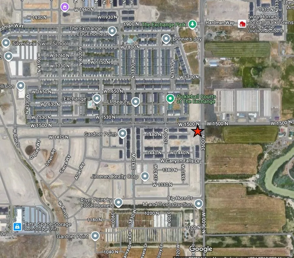 Satellite map. Displaying a specific location within a developed area, marked with a red star, and surrounding street grid and points of interest