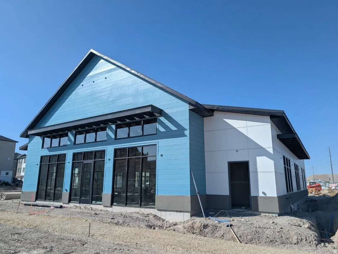 Contemporary exterior with blue horizontal siding and white paneling