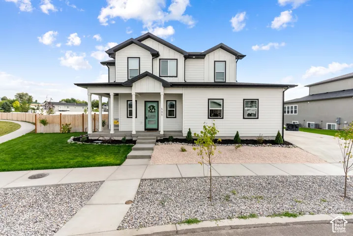 Contemporary two-story exterior featuring white horizontal and vertical siding with black trim accents