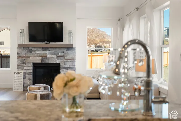 Stacked stone fireplace with a wood-finish mantel and a sleek black firebox
