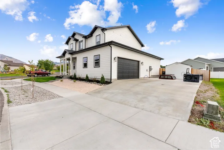 Modern two-story residence with a white exterior and dark trim