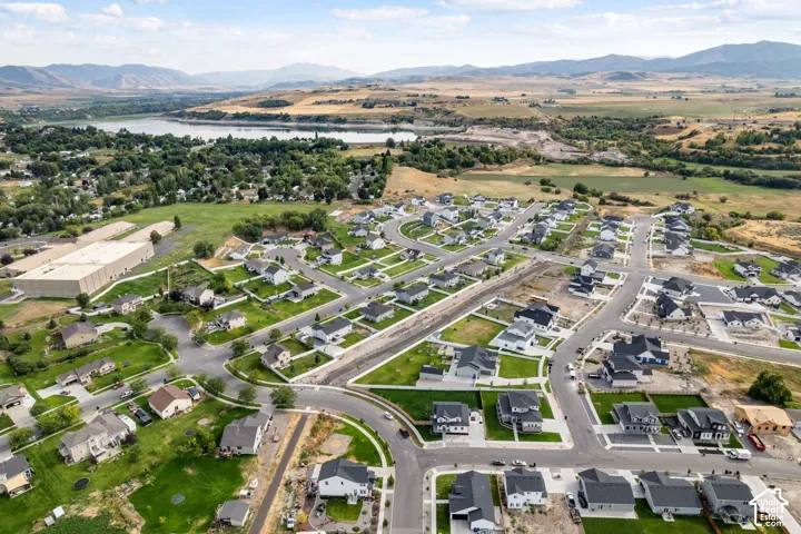Expansive residential development featuring modern homes with dark roofs and light-colored siding