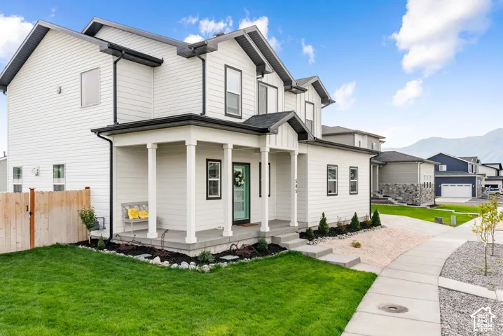 Contemporary two-story residence featuring white siding and black trim accents